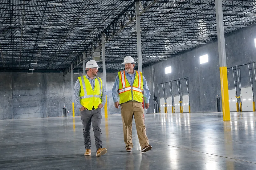 two workers walking in warehouse