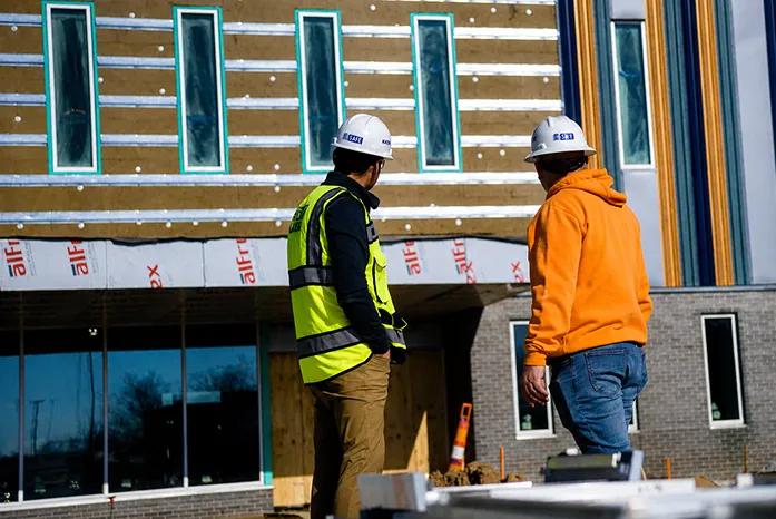 2 workers outside at a project